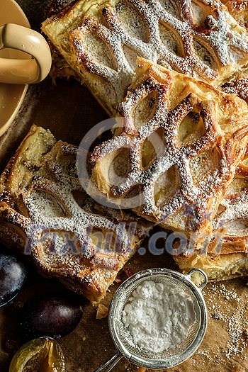 Close up dark rustic style Apple strudel. Sliced homemade apple strudel, top view. Close up dark rustic style Apple strudel. Sliced homemade apple strudel, top view.