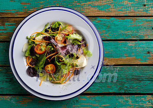 Healthy food. Fresh salad tomato, cheese and greens, top view, wooden table. Healthy food. Fresh salad tomato, cheese and greens, top view, wooden table.