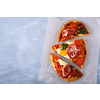 Sliced Homemade tasty pizza with bacon, egg, cheese, tomatoes and basil 