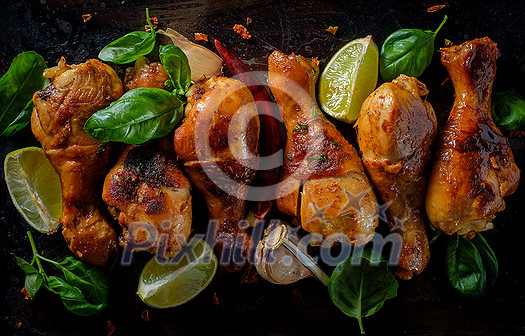 Grilled bbq spicy chicken legs on a metallic background. Top view. Grilled bbq spicy chicken legs on a metallic background. Top view.