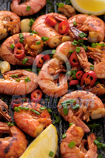 Large grilled BBQ shrimp with sweet chili sauce, green onion and lemon Large grilled BBQ shrimp with sweet chili sauce, green onion and lemon