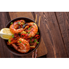 Large grilled BBQ shrimp with sweet chili sauce, green onion and lemon, copyspace.