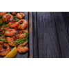 Large grilled BBQ shrimp with sweet chili sauce, green onion and lemon, copyspace.