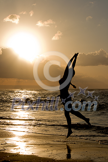 Girl jumping on sunrise at the beach Girl jumping on sunrise at the beach