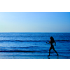 Female running along the beach at sunrise