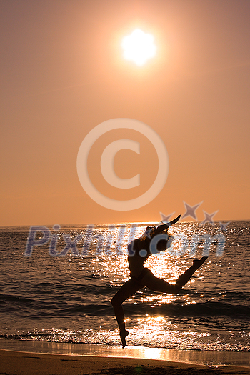 Female jumping at beach on sunrise Female jumping at beach on sunrise