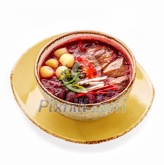 A plate of borsch with beets, meat and potatoes. Isolated on white background. A plate of borsch with beets, meat and potatoes. Isolated on white background.