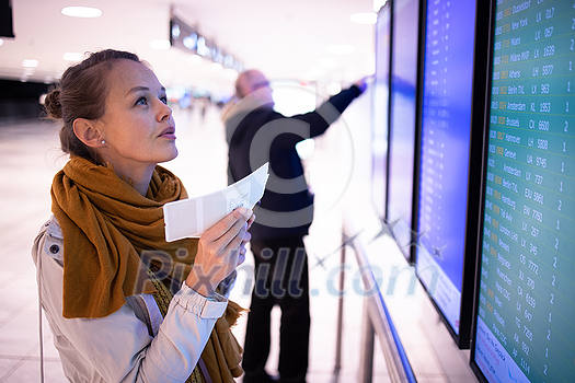 Canceled flight situation - Young, pretty female traveler learning about her flight being canceled, unable to get home today Canceled flight situation - Young, pretty female traveler learning about her flight being canceled, unable to get home today