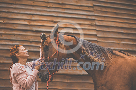 Pretty, young, redhead woman with her lovely horse, during her favorite leisure Pretty, young, redhead woman with her lovely horse, during her favorite leisure