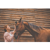 Pretty, young, redhead woman with her lovely horse, during her favorite leisure