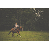 Pretty, young, redhead woman with her lovely horse, during her favorite leisure