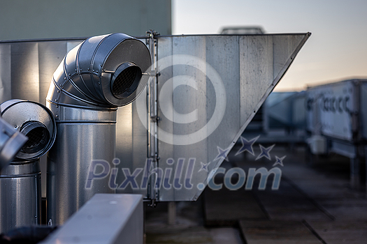 External unit of commercial air conditioning and ventilation system installed on industrial building roof. Exhaust vent on flat factory rooftop External unit of commercial air conditioning and ventilation system installed on industrial building roof. Exhaust vent on flat factory rooftop