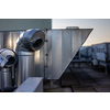 External unit of commercial air conditioning and ventilation system installed on industrial building roof. Exhaust vent on flat factory rooftop