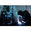 Man working on iron with grinder. Man at work. Sparkles and fire from grinder cutting. Grinder. Worker.