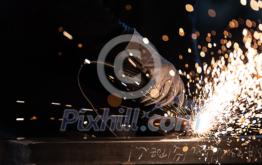 Man working on iron with grinder. Man at work. Sparkles and fire from grinder cutting. Grinder. Worker. Man working on iron with grinder. Man at work. Sparkles and fire from grinder cutting. Grinder. Worker.