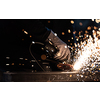 Man working on iron with grinder. Man at work. Sparkles and fire from grinder cutting. Grinder. Worker.