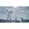 Industrial landscape with strong atmosphere wastes emission above large power plant or factory on a background of cloudy sunny sky in Budapest, Hungary.