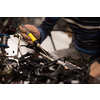Industrial worker man soldering cables of manufacturing equipment in a factory. Selective focus. High quality photo