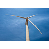 Green renewable alternative energy concept - wind generator turbine generating electricity in blue sky