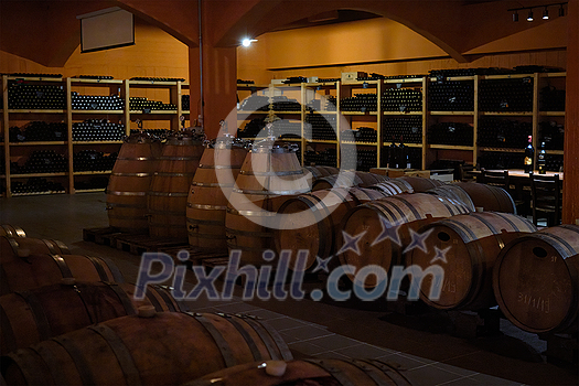 Winery cellar with wooden wine barrels. Crete island, Greece Winery cellar with wooden wine barrels. Crete island, Greece