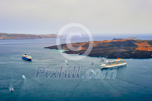 Cruise ships and tourist boats in sea. Greek isaldn Santorini, Greece. Toy camera tilt shift miniature effect Cruise ships and tourist boats in sea. Greek isaldn Santorini, Greece. Toy camera tilt shift miniature effect