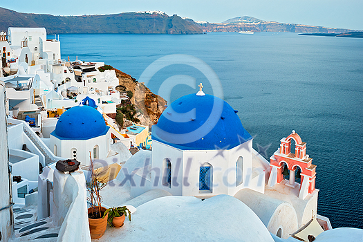 Famous view from viewpoint of Santorini Oia village with blue dome of whitewashed greek orthodox Christian church of traditional greek architecture. Oia town, Santorini island, Greece Famous view from viewpoint of Santorini Oia village with blue dome of whitewashed greek orthodox Christian church of traditional greek architecture. Oia town, Santorini island, Greece