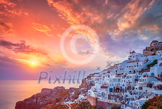 Scenic sunset over sea and picturesque Oia town on Santorini island in summer. Oia, Santorini, Greece Scenic sunset over sea and picturesque Oia town on Santorini island in summer. Oia, Santorini, Greece