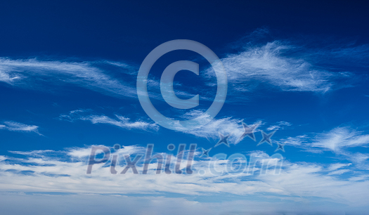 Blue clear sky with white cirrus spindrift clouds background