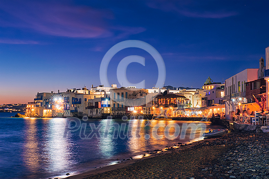 Harbor and colorful waterfront houses of Little Venice romantic spot illuminated in night. Mykonos townd, Greece Harbor and colorful waterfront houses of Little Venice romantic spot illuminated in night. Mykonos townd, Greece