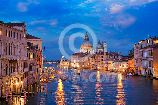 View of Venice Grand Canal with boats and Santa Maria della Salute church in the evening from Ponte dell'Accademia bridge. Venice, Italy View of Venice Grand Canal with boats and Santa Maria della Salute church in the evening from Ponte dell'Accademia bridge. Venice, Italy