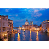 View of Venice Grand Canal with boats and Santa Maria della Salute church in the evening from Ponte dell'Accademia bridge. Venice, Italy