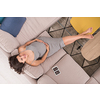 top view of a young pregnant woman looking baby's ultrasound photo while relaxing on sofa at home