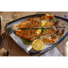 Grilled fish with lemon on a plate