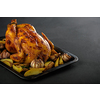 Roasted chicken with potatoes on a baking sheet. Copyspace.